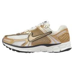 Zapatilla de running mujer oro metálico